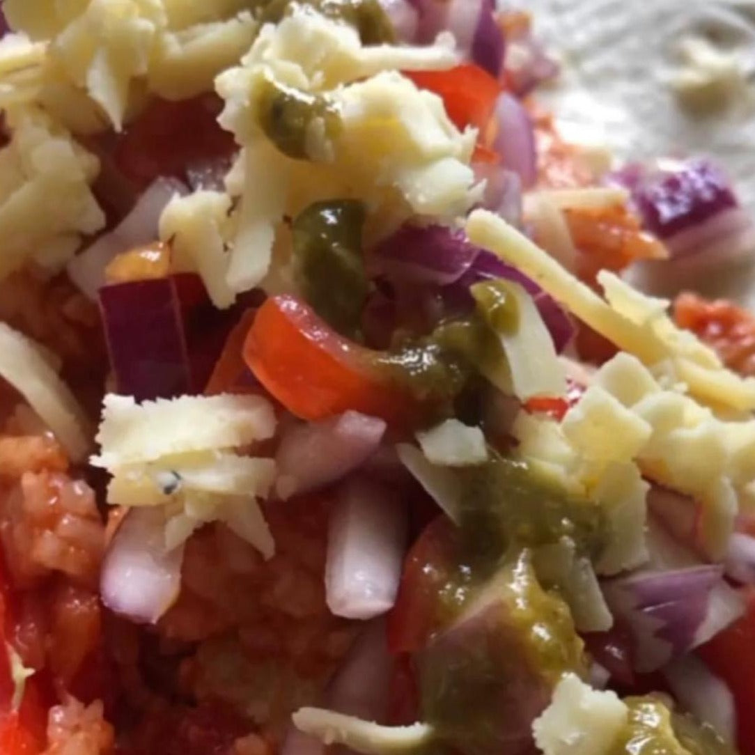 A soft flour tortilla with cheese, vegetables and drizzled with Tasty Jalapeño