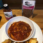 A picture of vegetarian BBQ ribs and potato wedges, featuring a packet of Scorpion BBQ sauce and 'Therein Lies The Rub'