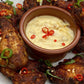A picture of home made BBQ wings with a pot of Moruga Fire mayonnaise